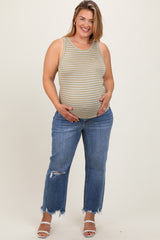 woman wearing a green and white striped maternity tank top and blue distressed jeans, highlighting her baby bump