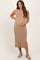 woman wearing a beige ribbed maternity dress with short sleeves and a button placket, cradling her baby bump
