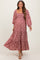 woman wearing a pink floral maternity dress with long puff sleeves and a tiered skirt
