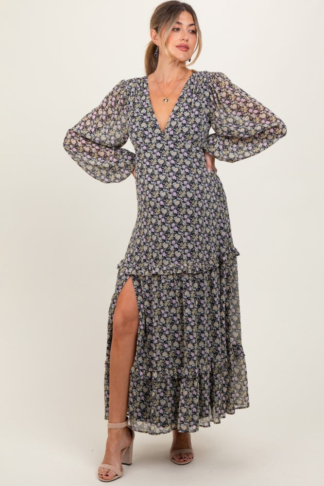 woman wearing a floral maternity maxi dress with long puff sleeves and a thigh-high slit, showing off her baby bump