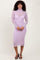 woman wearing a light purple long sleeve fitted dress with a turtleneck and sheer overlay