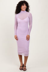 woman wearing a lavender long sleeve fitted dress with a sheer overlay and a mock neck