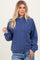 woman wearing a navy blue cropped hoodie with a drawstring and relaxed fit, paired with light blue jeans
