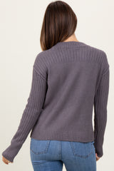 woman wearing a grey maternity sweater with ribbed detailing and a relaxed fit, showing her back