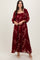 woman wearing a burgundy floral maxi dress with long sleeves and a square neckline