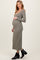 woman wearing a long sleeve olive green maternity dress and showcasing her baby bump