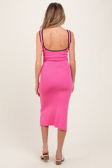 woman wearing a hot pink maternity dress with a fitted silhouette and spaghetti straps, showing her back