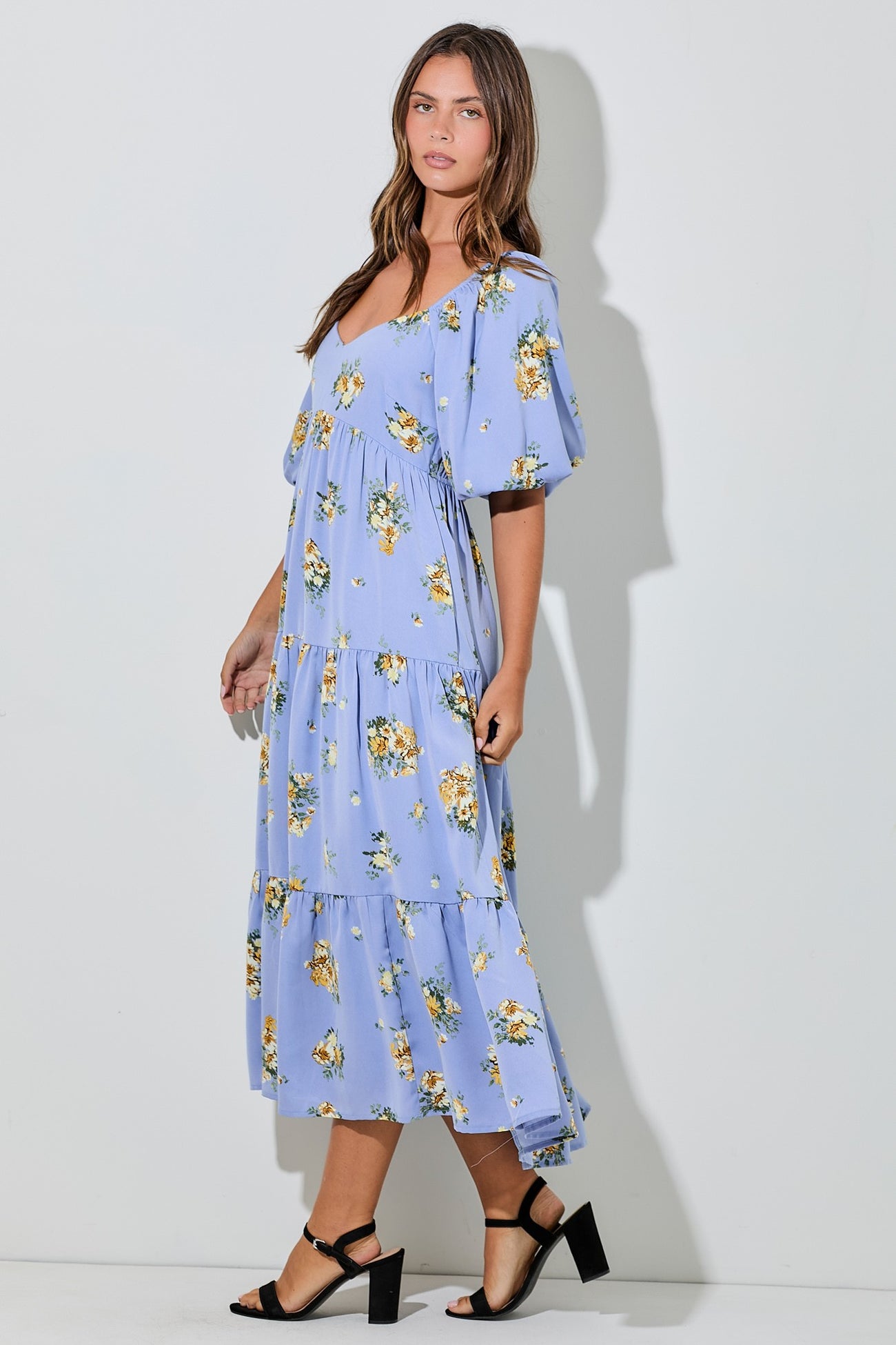 woman wearing a lavender floral maxi dress with tiered ruffles and short puff sleeves