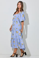 woman wearing a lavender floral maxi dress with tiered ruffles and short puff sleeves