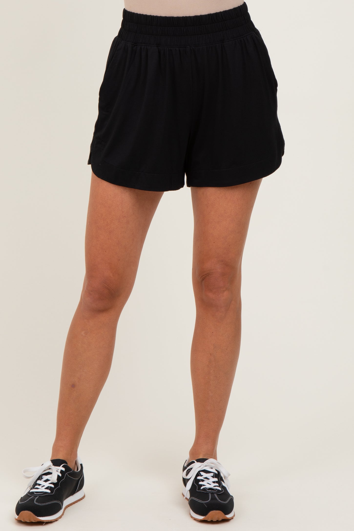 woman wearing black athletic shorts with an elastic waistband and side pockets