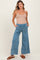 woman wearing light blue maternity wide-leg pants with pockets and a drawstring waist