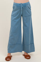 woman wearing light blue wide-leg maternity pants with pockets and drawstring waistband