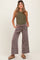woman wearing olive green ribbed maternity tank top and grey wide-leg maternity pants with pockets and drawstring waist