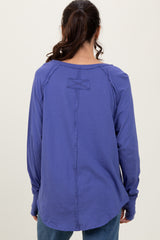 woman wearing a purple long sleeve shirt with a unique back detail and relaxed fit