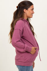 woman wearing a pink ribbed maternity hoodie with a front pocket and visible baby bump