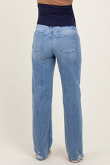 woman wearing high-waisted light blue maternity jeans with a relaxed fit, showing the back view