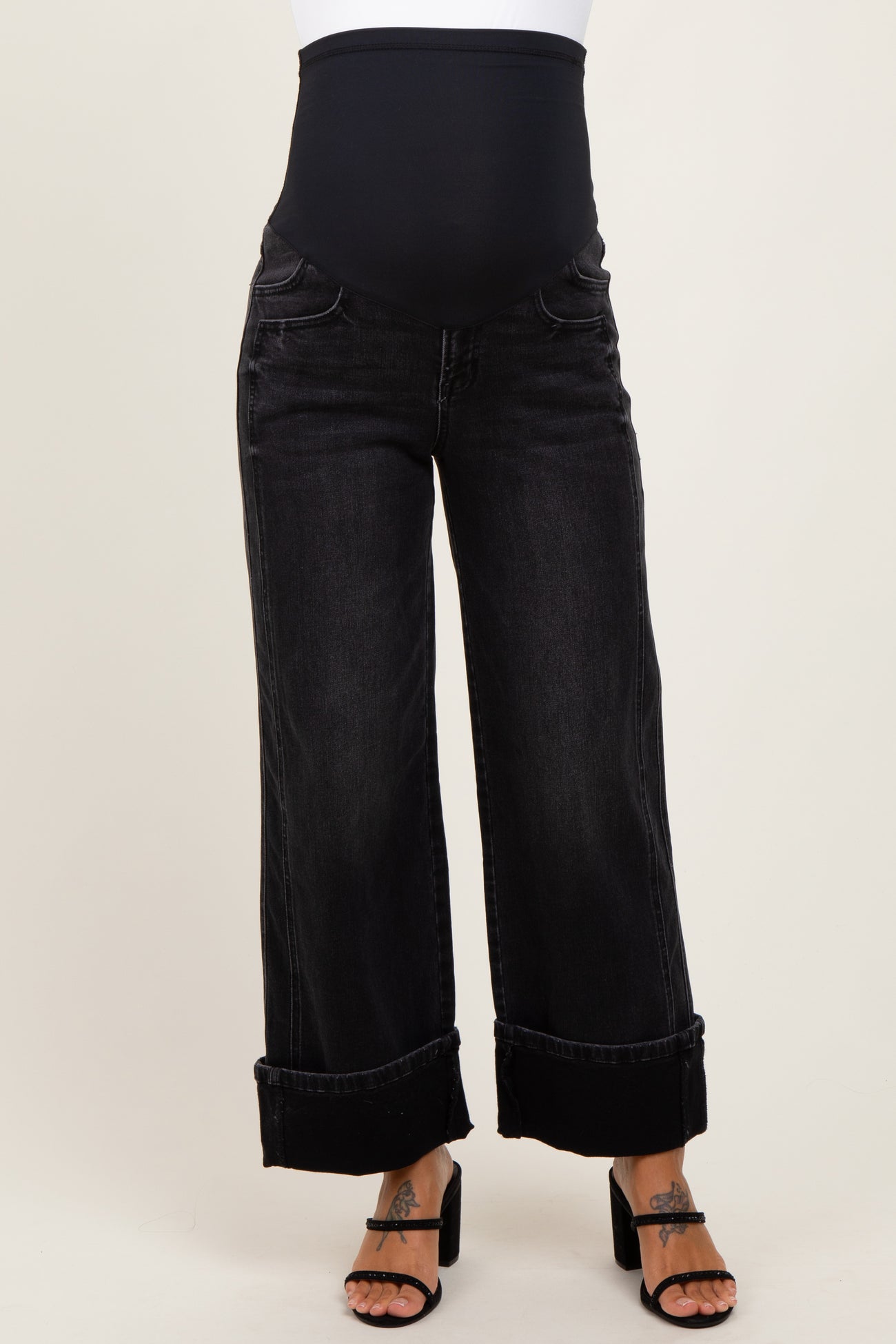 maternity wear black wide leg jeans with a supportive over-the-bump waistband, model wearing black high heel sandals