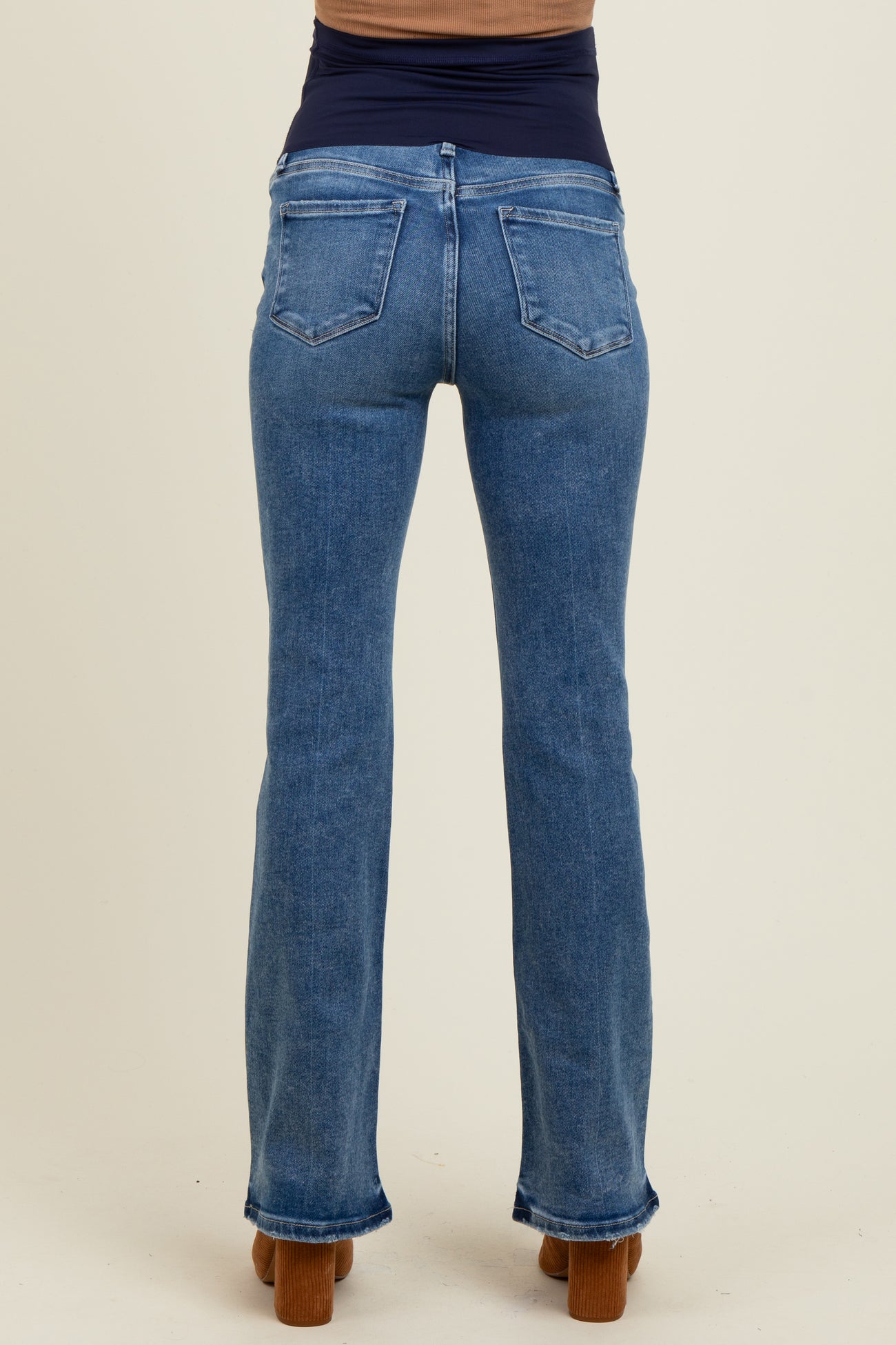 maternity wear light blue flared jeans shown from the back on a model with a fitted dark top