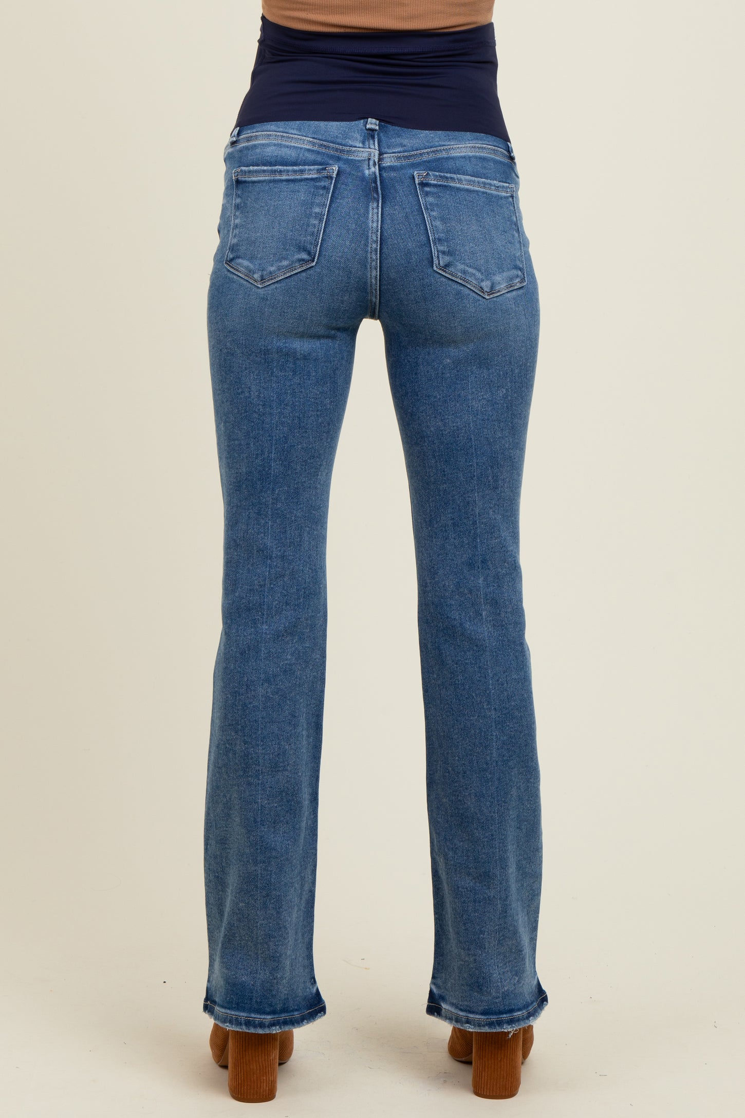 maternity wear light blue flared jeans shown from the back on a model with a fitted dark top