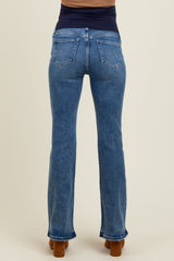 maternity wear light blue flared jeans shown from the back on a model with a fitted dark top