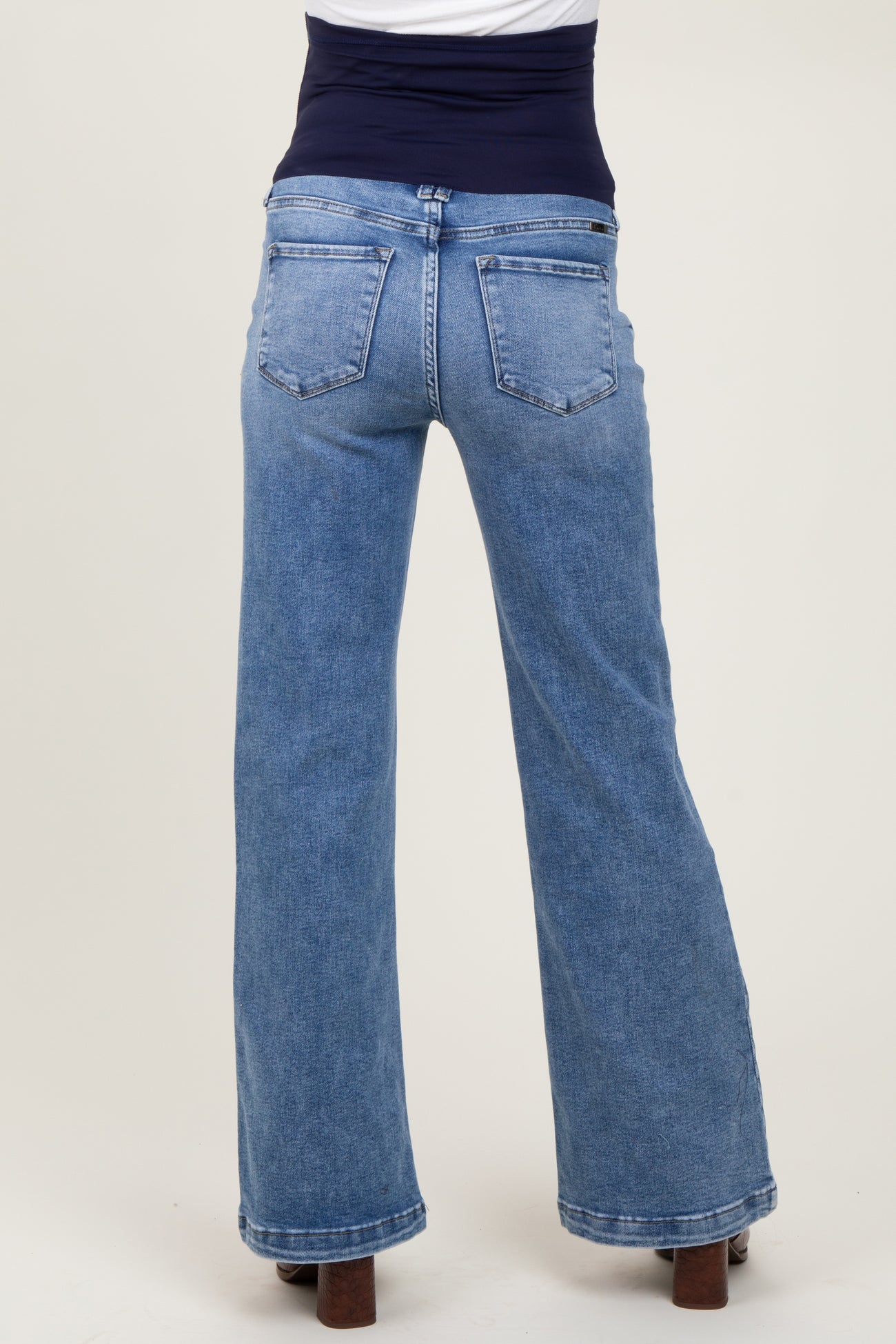 woman wearing light blue maternity wide-leg jeans with a supportive waistband, back view
