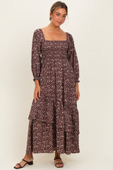 woman wearing a brown floral long sleeve maxi dress with a square neckline and tiered skirt