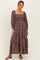 woman wearing a brown floral long sleeve maxi dress with a square neckline and tiered skirt