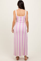 woman wearing a fitted pink and white striped maxi dress, showing the back view