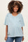 woman wearing a light blue maternity top with short sleeves and a relaxed fit, showing her baby bump