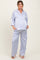 woman wearing a light purple maternity pajama set with a button-up top and wide-leg pants, showing her baby bump