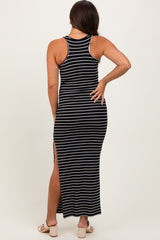 woman wearing a black and white striped maternity maxi dress with a racerback and side slits, showing a baby bump