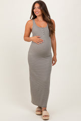 woman wearing a striped grey maternity maxi dress with buttons and holding her baby bump
