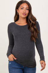 woman wearing a dark grey ribbed long sleeve maternity top and showing her baby bump
