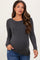 woman wearing a dark grey ribbed long sleeve maternity top and showing her baby bump