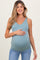 woman wearing a teal maternity tank top and holding her baby bump