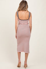 woman wearing a striped pink and black midi maternity dress, showing a fitted silhouette from the back