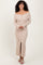 woman wearing a beige off-the-shoulder ribbed maxi dress with a button-down front and a thigh-high slit