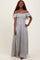 woman wearing a gray and white striped off-the-shoulder maxi dress with a fitted bodice and flowy skirt