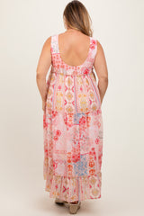 woman wearing a colorful patterned maternity plus maxi dress with a tiered design and a scoop back