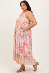 woman wearing a colorful floral print plus size maxi dress with pockets and ruffle hem, standing sideways