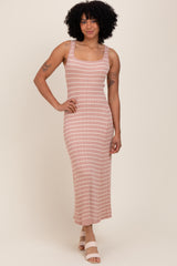 woman wearing a mauve striped sleeveless midi dress with a fitted silhouette and standing on a neutral background