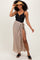 woman wearing a black ribbed swimsuit top and a tan wrap maxi skirt, accessorized with a straw hat and slip-on sandals