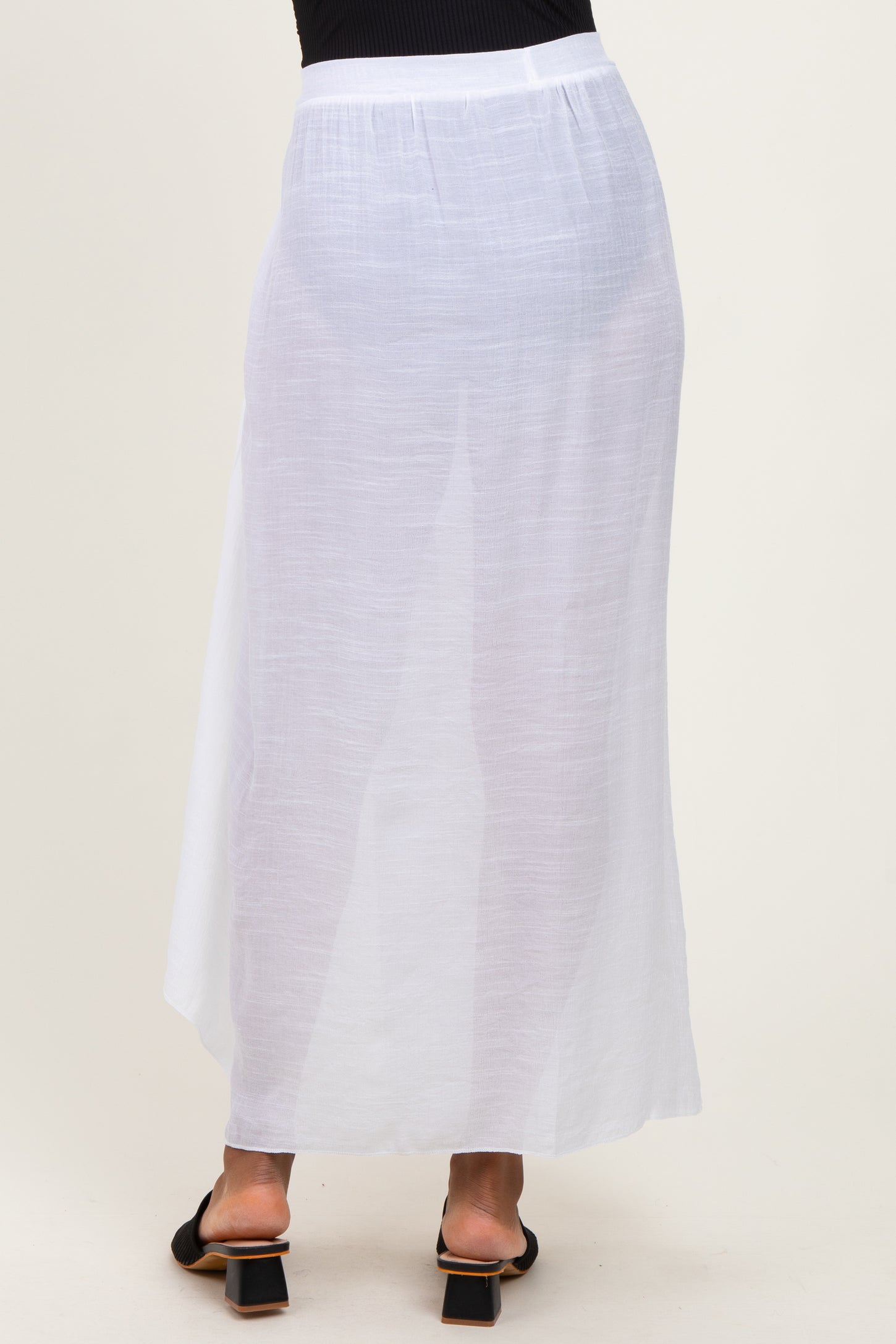 woman wearing a flowy white maxi skirt with a lightweight fabric and a comfortable waistband