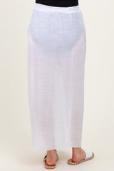 woman wearing a white sheer maternity maxi skirt, view of the back, featuring a relaxed fit and flowing fabric