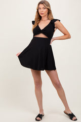 maternity wear in black featuring a twist front and ruffled sleeves, a flared skirt, model holding the dress out