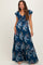 woman wearing a floral print navy blue maternity maxi dress with short flutter sleeves and a tie front detail