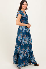 woman wearing a blue floral maxi dress with ruffled sleeves and a fitted bodice