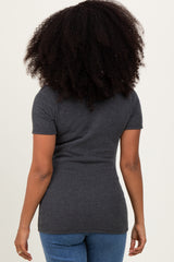 woman wearing a charcoal gray ribbed short sleeve top and blue jeans, seen from the back