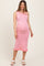 woman wearing a pink striped maternity dress with ruffle hem and a visible baby bump