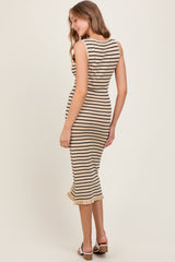 woman wearing a beige and black striped sleeveless midi dress with a ruffled hem and styled with heeled sandals